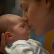 Mother kissing newborn baby RSV Prevention